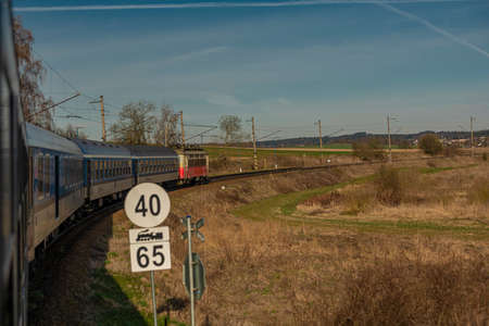 Fast electric train with coaches from Brno to Plzen in spring morning near Jihlava city