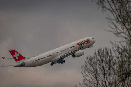 Takeoff of airplanes in Zuich airport in spring 2022 04 03 in cloudy evening