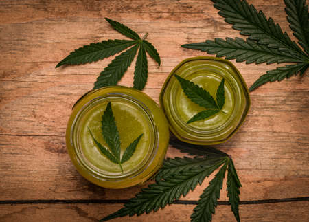 New fresh marijuana salve in glass on old wooden dirty tableの写真素材