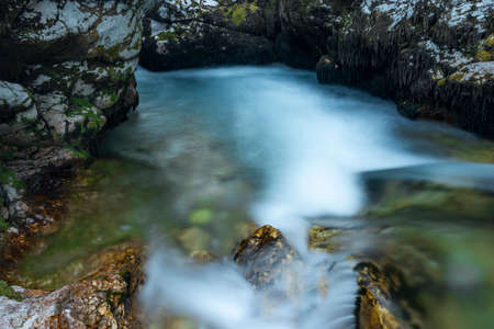 Light blue water in Soca river in summer hot evening in Slovenia mountainsの写真素材