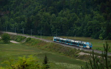 Trains in deep valley of river Sava near Radovljica town in summer Slovenia