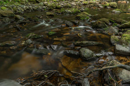 Chomutovka dark river in deep valley near Chomutov town in dry year without rain