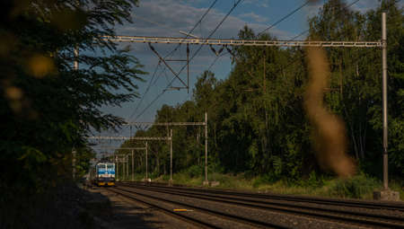 Trains on main Czech railway Prague Kolin in summer hot sunny evening