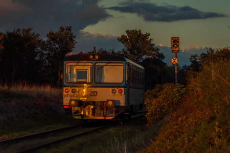 Czech passenger old train with orange sunset near Rakovnik town in central Bohemiaのeditorial素材