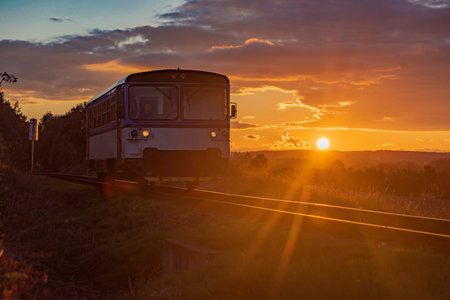 Czech passenger old train with orange sunset near Rakovnik town in central Bohemiaの写真素材
