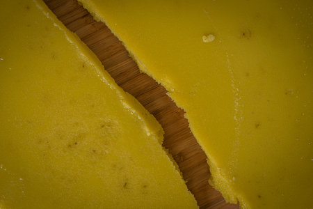 Yellow marijuana butter on light stone table with dish towel and color ceramic cupの写真素材
