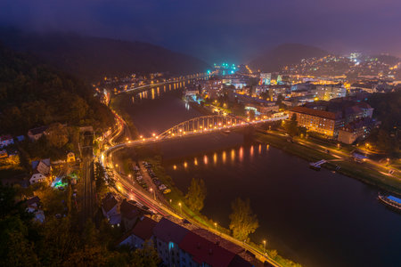 Decin town from above in dark mist evening in fresh autumnの写真素材