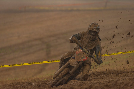 Dirty championship in cloudy sludge autumn day on motorbike near Vysoke nad Jizerou townのeditorial素材