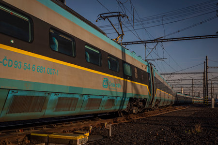 Super fast train in color of Czech republic on Prague main station in autumn sunny evening