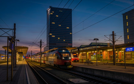 Linz railway station in color autumn evening after nice sunsetのeditorial素材