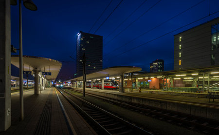 Linz railway station in color autumn evening after nice sunsetのeditorial素材