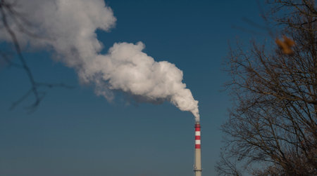 Color chimney with white smoke and light blue background