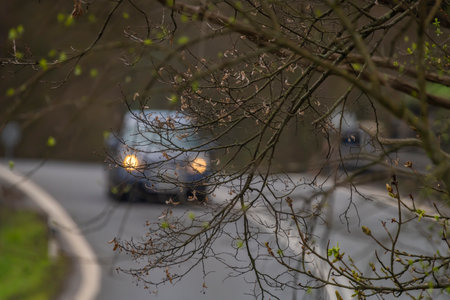 Cars in curve near Zahradky village in spring cloudy fresh eveningの写真素材