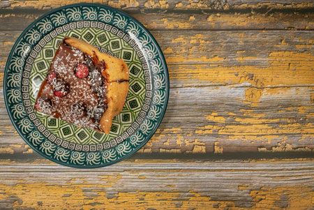 Marijuana cake with dry red currants and chocolate on arabic color plateの写真素材