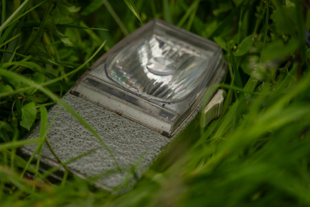 Old hand torch in green grass in spring fresh nice dayの写真素材