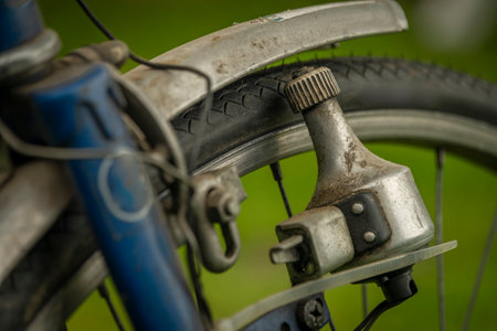 Detail of blue old dirty bicycle in green spring grass color dayの写真素材