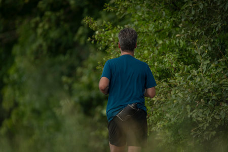 Runner on cycle route in summer color sunny fresh day
