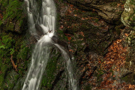 Hutsky waterfall in Krkonose mountains and national park in cloudy summer day