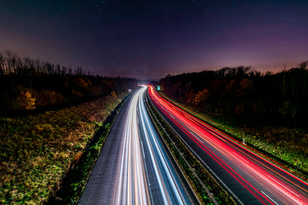 Night on highway and car lines with pedestrian bridge Cat eyes near Chlumec north Bohemia town