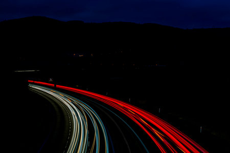 Night on highway and car lines with pedestrian bridge Cat eyes near Chlumec north Bohemia town
