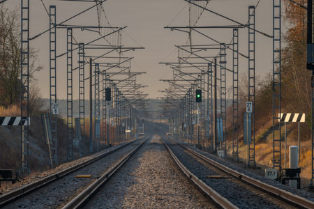 Fast railway electric tracks in cold winter fresh morningの写真素材
