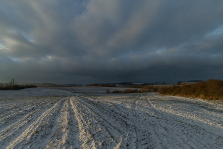 Sunrise with orange sun and winter snowy landscapeの写真素材