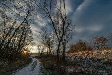 Sunrise with orange sun and winter snowy landscapeの写真素材