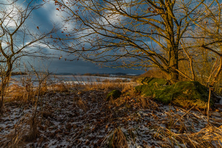 Sunrise with orange sun and winter snowy landscape near Nepomuk Bohemia townの写真素材