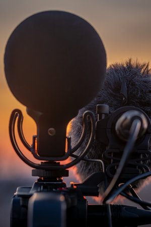 Camera and microphones on tripod in mountains with sunset near Vysoke nad Jizerou in north Bohemia