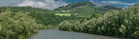 Salzach river with blue water in cloudy summer hot day near Pfarrwerfenの写真素材