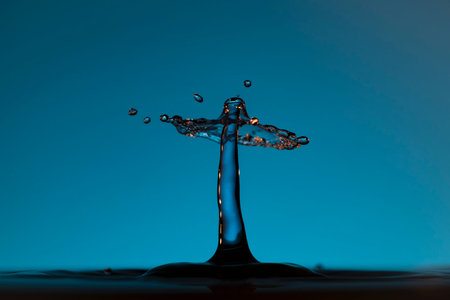 Color drops splash with umbrella or balls in fresh clean waterの写真素材