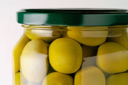 Glass jar of preserved olives (horizontal closeup)の写真素材