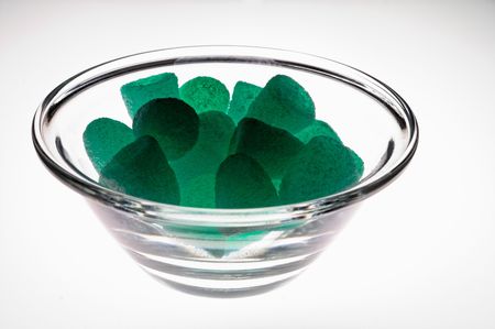 Jelly mints in glass cup  on light table (illuminated from below)の写真素材