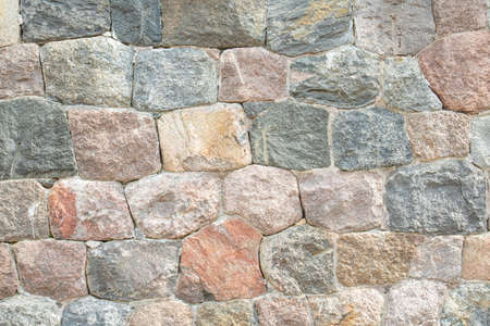 old fortress wall made of natural stone close-upの写真素材
