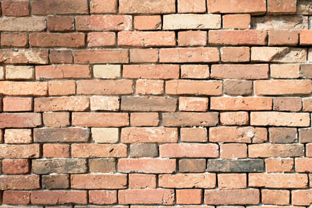 old brick wall in orange color with empty seamsの写真素材