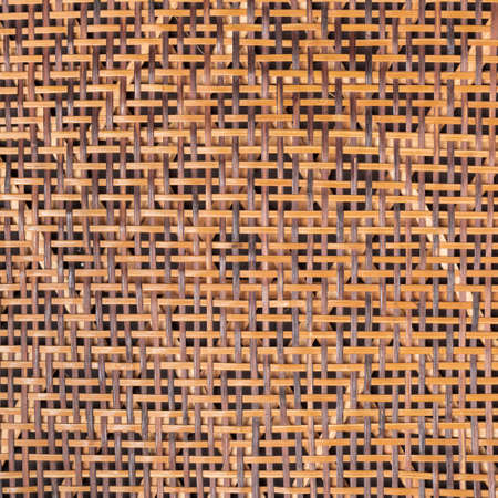 texture of weaving cane stems in orange colorの写真素材