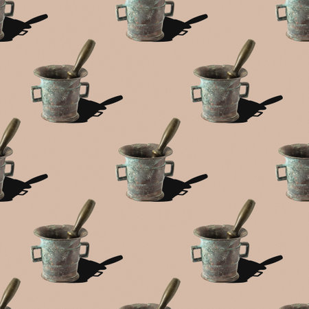 pattern from a bronze mortar with a pestle on a beige backgroundの写真素材