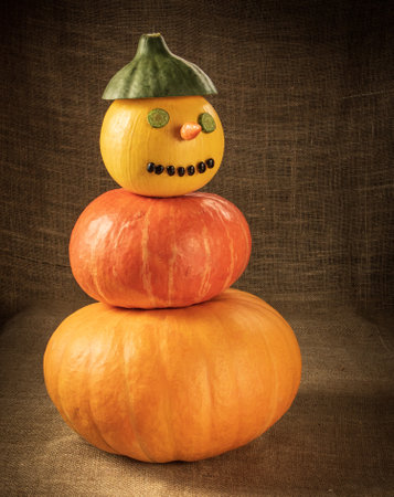 Snowman made of ripe pepper and bean pumpkinsの写真素材