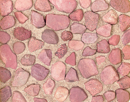 Texture of red river stones on the sandの写真素材