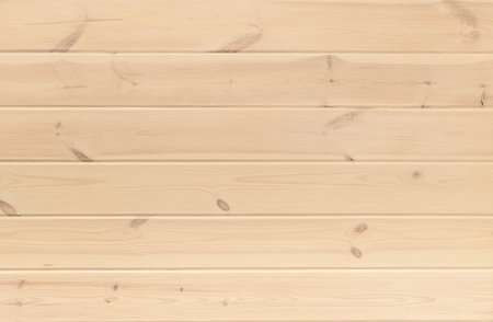 Background wall of horizontal textured pine planks in warm pastel colorの写真素材