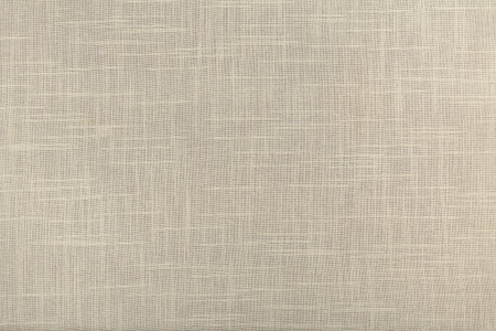 finely textured background of beige linen fabric