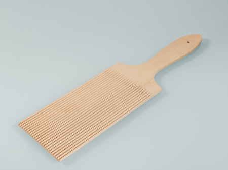 Wooden kitchen utensils. Wooden spatula with parallel grooves for working with doughの写真素材