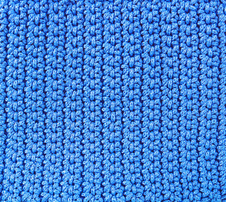Knitted background.Texture of rough knitting from blue woolen threadsの写真素材