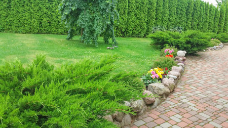 Path of tiles in the decorative garden near the houseの写真素材
