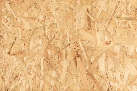 Bright contrasting background of chipboard rough texture yellowの写真素材