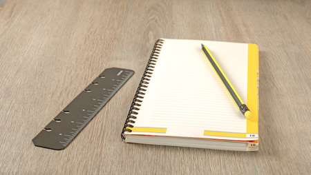 Office theme. Pencil, ruler and notepad on a gray office table close-upの写真素材
