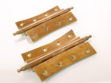 Furniture fittings. Two brass retro hinges with traces of patina from early 20th century furnitureの写真素材