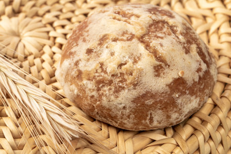 Russian gingerbread next to an ear of barley lies in a wicker basket,close up