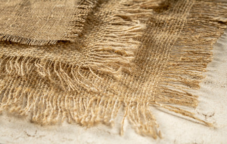 Stack of burlap napkins with fringe close-up, rustic style.の写真素材