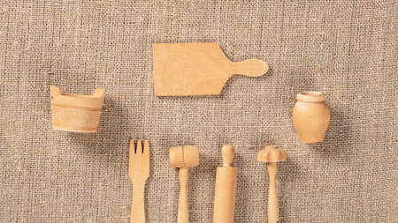Top-Down Shot of Wooden Kitchen Utensils on Burlap Texture Backgroundの写真素材
